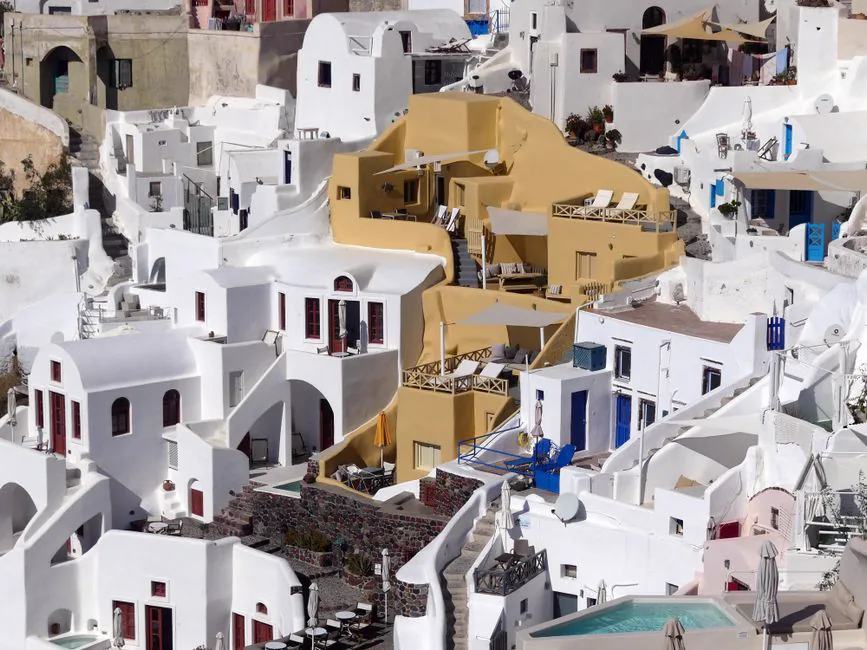 Aerial view of Santorini's iconic white and colored buildings in Fira, Greece.