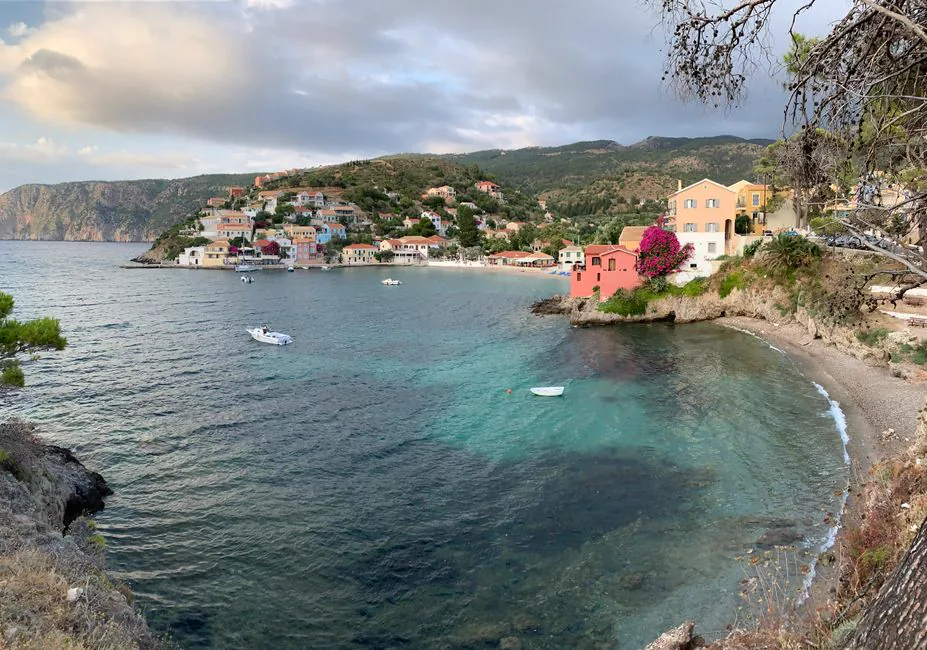 A picturesque view of Asos village in Greece, featuring vibrant houses along the serene coastline.