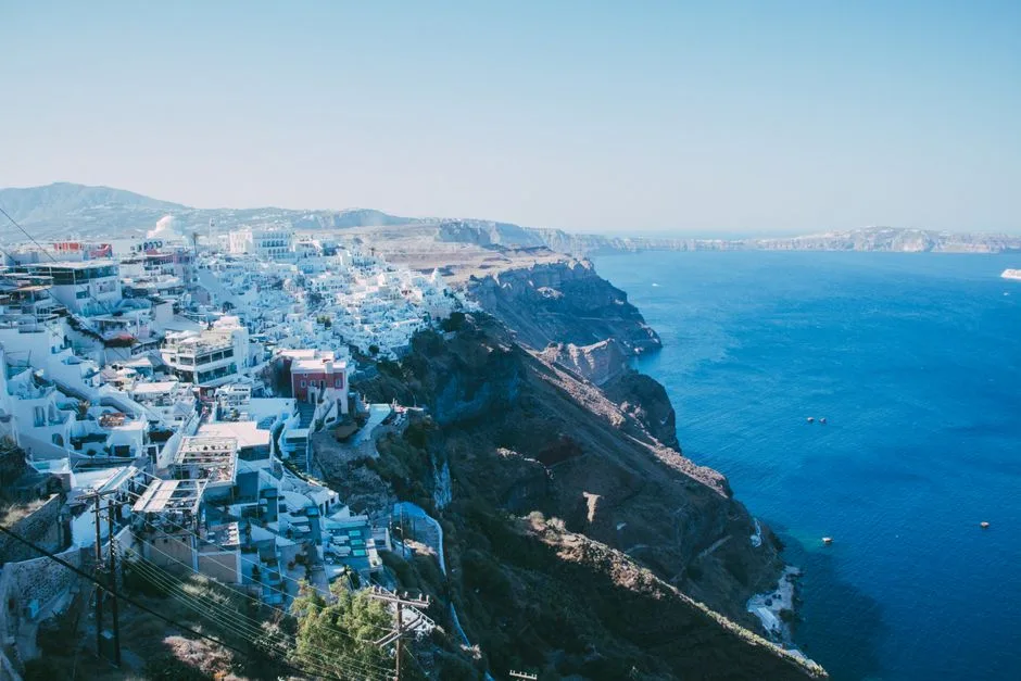 Breathtaking aerial view of Santorini's iconic cliffside architecture and deep blue sea.