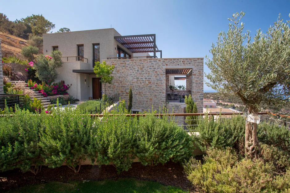 Elegant stone villa in Bodrum, Turkey with lush gardens and scenic views.
