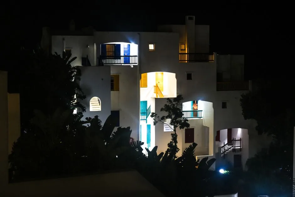 Illuminated white architecture in Santorini at night showcasing iconic Greek design.